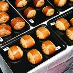 Des pains au chocolat dorés et feuilletés, certains numérotés, prêts à être dégustés. Le meilleur pain au chocolat de Paris se trouve peut-être ici !