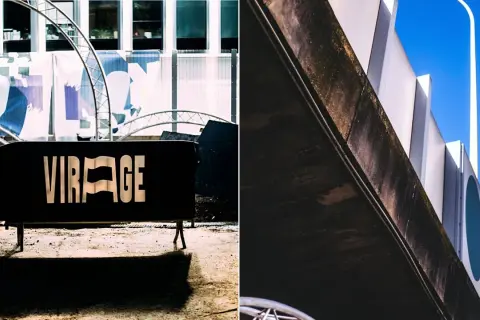 Panneau noir "VIRAGE" devant un bâtiment moderne. Le virage parisien est prêt.