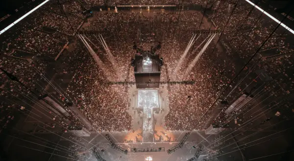 Vue aérienne d'une arène bondée, prête pour un événement. La capacité de la défense est impressionnante, avec des milliers de spectateurs.