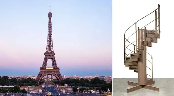 Escalier en colimaçon en métal, rappelant celui du 1er étage de la Tour Eiffel, sur fond blanc.
