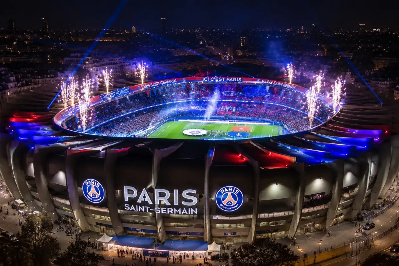 Feu d'artifice au Parc des Princes, illuminant le stade et la foule en délire. Paris Saint-Germain brille de mille feux.
