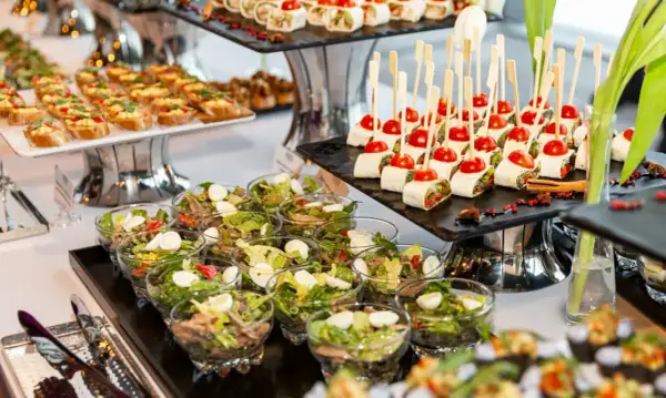 Un festin de **brunch à volonté Paris** : mini wraps, toasts garnis, salades individuelles et brochettes de tomates cerises.