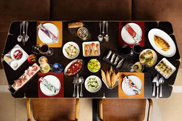 Un festin de tapas et de charcuterie sur une table de restaurant Paul Pairet.