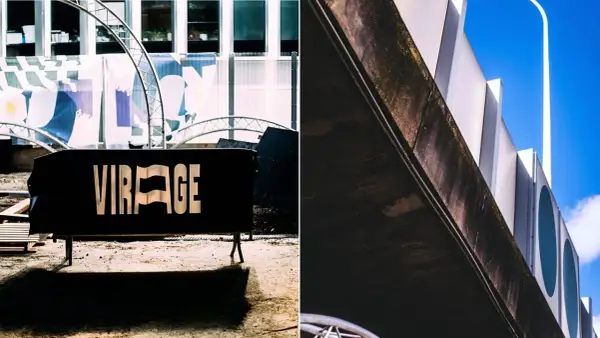 Panneau noir "VIRAGE" devant un bâtiment moderne. Le virage parisien est prêt.